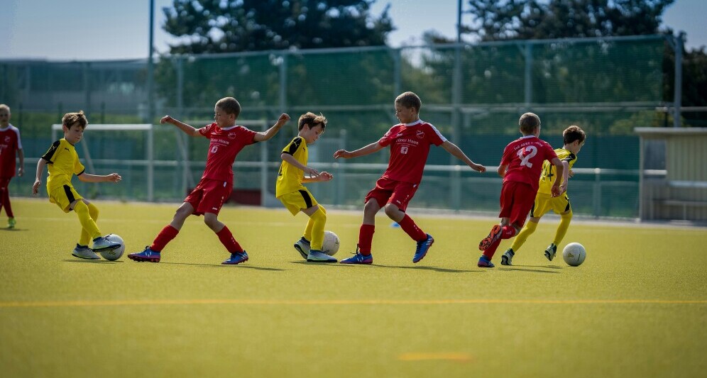 young players dribbling