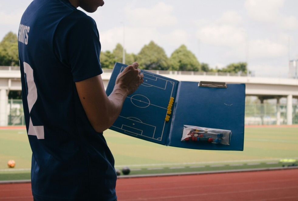 coach showing a soccer board